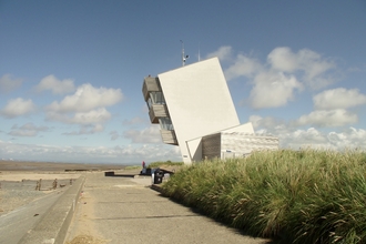 A large modern tower on a beach