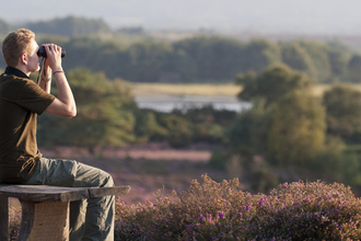 Man looking through binoculars