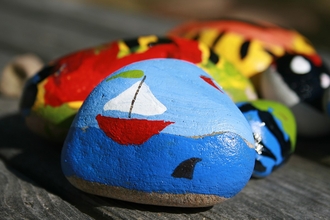A pebble with a painting of a rock on it