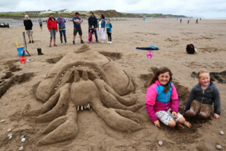 People by a sandcastle