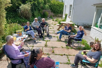 A group of people having drinks in the sunshine