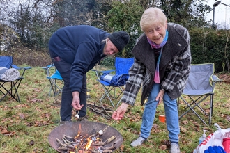Toasting marshmallows over a firepit
