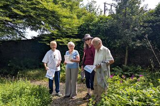 Four people in a garden.