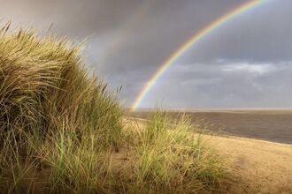 Rainbow over the sea at Fleetwood with the sand dunes in the foreground.