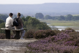 Couple enjoying view from a bench