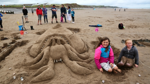 People by a sandcastle