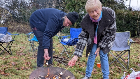Toasting marshmallows over a firepit