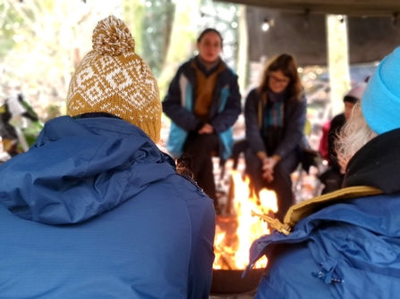 People sitting around a campfire