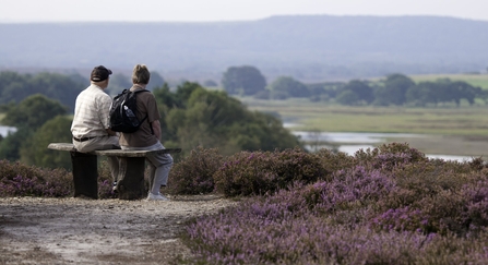 Two people on a bench at a nature reserve