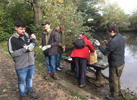 5 people making lanterns decorated with leaves