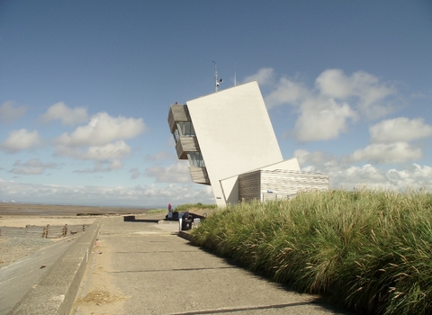 A large modern tower on a beach