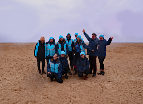 The Bay team on a beach