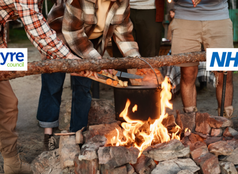 People cooking over an open fire