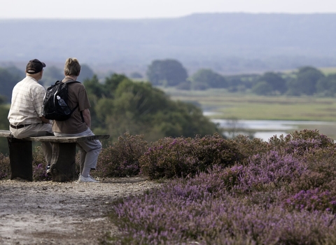 Couple enjoying view from a bench